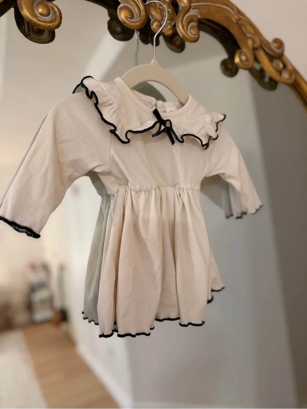 Cream Ruffle Baby Dress with Black Trim